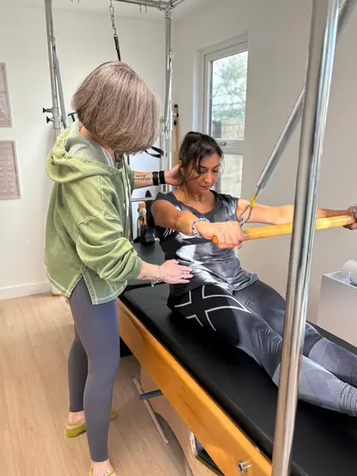 Personal trainer Liz Shaw coaching a client on the Pilates reformer at The Willow Studio, Ealing
