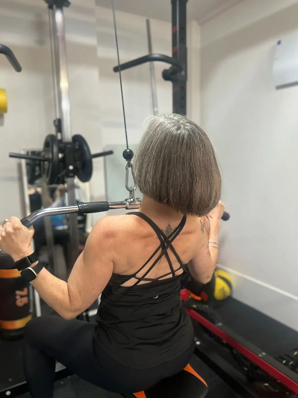 Liz Shaw strength training on the lat pulldown at The Everstrong Gym, Ealing